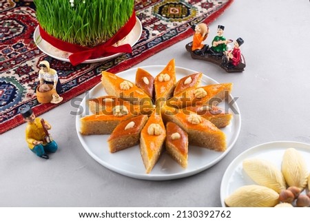 Plate of Azerbaijani national pastries for Novruz - Ganja and Baku style pakhlava on ethnic rug or carpet for Novruz, spring equinox and new year celebration in March. Copy space   Royalty-Free Stock Photo #2130392762
