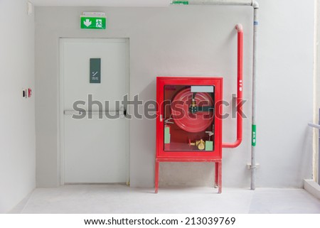 Fire exit door and fire extinguish equipment Royalty-Free Stock Photo #213039769