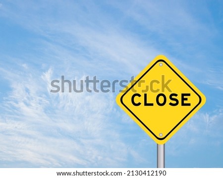 Yellow transportation sign with word close on blue color sky background