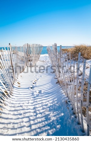 Snow fences on the beach. Beach access at the Atlantic Ocean on Cape Cod. 