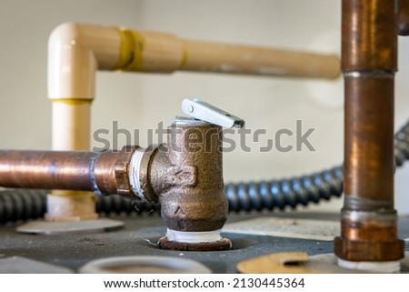 Residential hot water heater pressure relief valve. Royalty-Free Stock Photo #2130445364