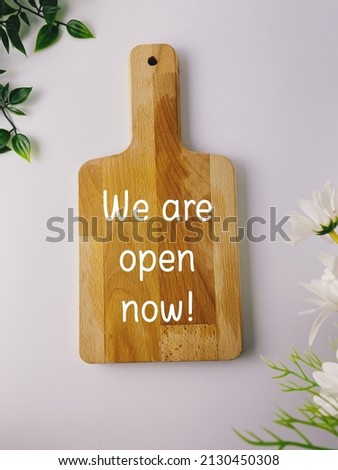 Label we are open now on wooden board