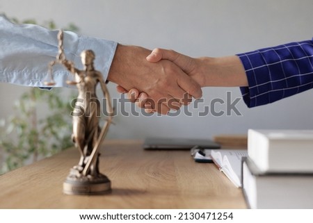 handshake of a female lawyer at a meeting with a male client in the office of the law office, legal advice online. resolution of disputes of the family code during divorce and division of property Royalty-Free Stock Photo #2130471254