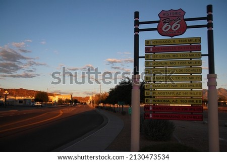 The traffic sign with all the destinations in a orange sunset at Kingman in Arizona