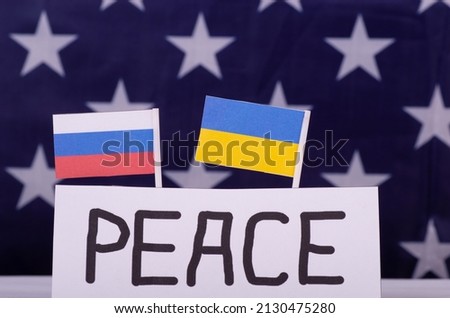 Ukraine and Russia two flags together with PEACE sign on USA flag background.