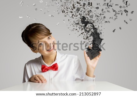 Young woman holding mobile phone with splashes