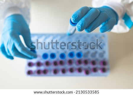 Process of coronavirus PCR antigen testing examination by nurse medic in laboratory lab, COVID-19 swab collection kit, test tube for taking OP NP patient specimen sample, patient receiving a test Royalty-Free Stock Photo #2130533585