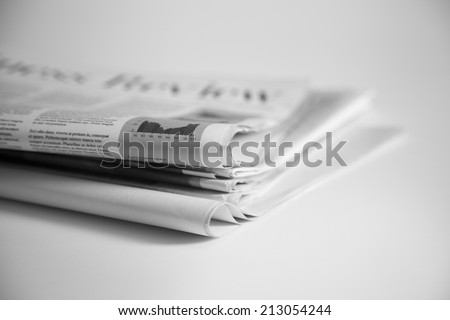 Newspapers folded and stacked Royalty-Free Stock Photo #213054244