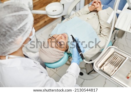 High angle portrait of female dentist prepping young woman for dental work in modern clinic