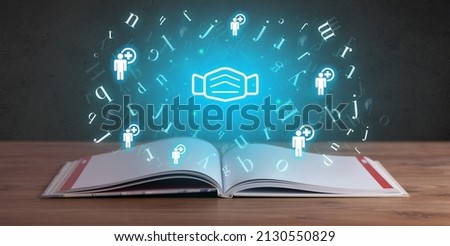 Open medical book with health icons above Royalty-Free Stock Photo #2130550829