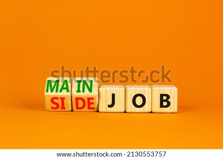 Extra or side job symbol. Turned wooden cubes and changed concept words Side job to Main job. Beautiful orange table orange background, copy space. Business side or main job concept. Royalty-Free Stock Photo #2130553757