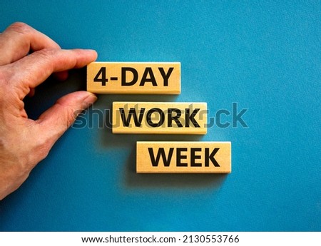 4-day work week symbol. Concept words 4-day work week on wooden blocks on beautiful blue table blue background. Businessman hand. Copy space. Business and 4-day work week and short workweek concept. Royalty-Free Stock Photo #2130553766