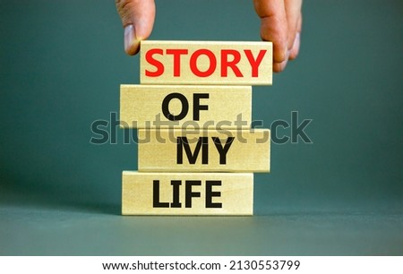 Story of my life and storytelling symbol. Concept words Story of my life on wooden blocks. Businessman hand. Beautiful grey table grey background. Story of my life business concept. Copy space.