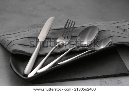 dining cutlery set on non isolated background Royalty-Free Stock Photo #2130562400