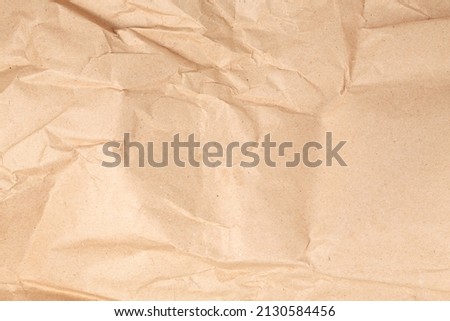 Light beige crumpled kraft paper texture background