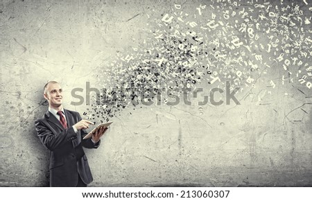 Young businessman holding tablet pc and letter flying in air
