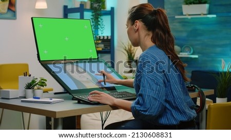 Editor retouching pictures and having green screen on computer. Photographer using touch screen for image retouch while looking at chroma key with mockup template and isolated background
