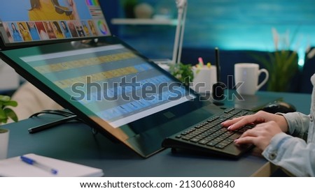 Woman photographer working with editing app on touch screen computer in workplace. Graphic designer using technology, equipment and retouching software for media production. Photography edit