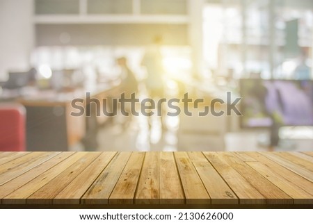 Plank wooden table top and blurred abstract background from interior building banner backdrop with desk blur, counter work people in workplace and kitchen - can used for display or your products.