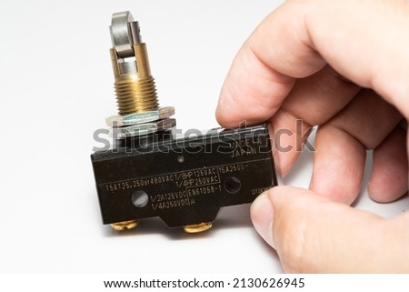 Limit switch sensor of the machine. Tiny limit switch for mechanical movement and actuators limits. isolated, white background of limit switch, control device, electrical equipment in control system.