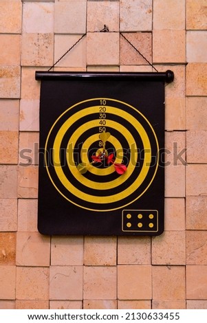 magnetic darts game hanging on rustic wall, dart game, aim target game, Children's Day



