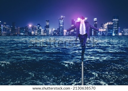 Picture of male manager walking on the rope with flood city background