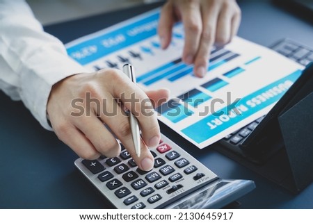 Businessman doing finances and calculate about cost to investment , business Financing Accounting Banking Concept, tax system