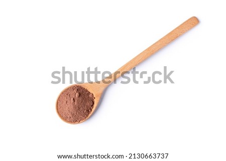 Cocoa powder in wooden spoon isolated on white background. Top view. Flat lay.