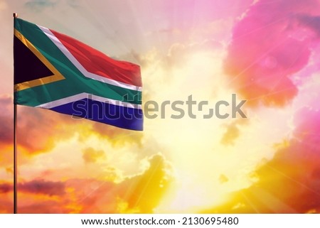 Fluttering South Africa flag in left top corner mockup with the place for your information on beautiful colorful sunset or sunrise background.
