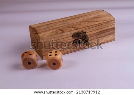 Two wooden box and dice isolated against a white background