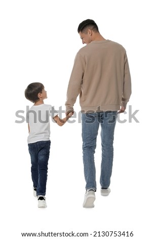 Little boy with his father on white background, back view Royalty-Free Stock Photo #2130753416
