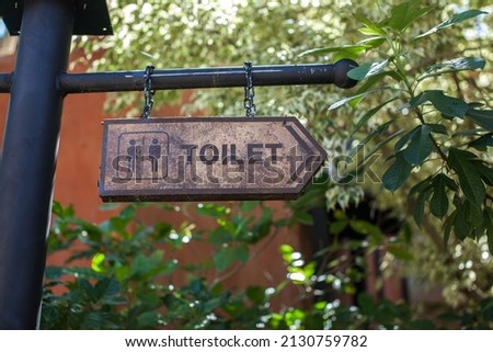 Toilet sign hanging on the pole