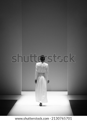 Fashion model at a catwalk during a fashion show or fashion week.