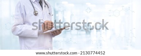 Healthcare and medical, telemedicine, medical technology concept. Medicine doctor with stethoscope using digital tablet computer with blurred hospital and patient background Royalty-Free Stock Photo #2130774452