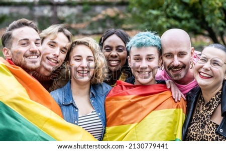 Group of young activist for lgbt rights with rainbow flag, diverse people of gay and lesbian community