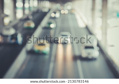 The Blurred image of a car driving on the road Traffic and bokeh from the melting of the len 
used. for scene background or wallpaper and design work.