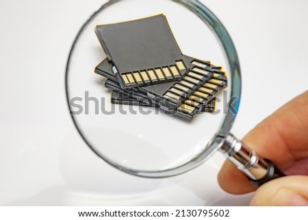 Close up memory cards and handheld magnifying glass