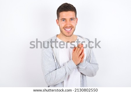 young caucasian man wearing casual clothes over white background , feeling happy, smiling and clapping hands, saying congratulations with an applause.
