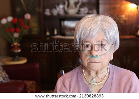 Senior woman using nasal cannula due to lack of oxygen  Royalty-Free Stock Photo #2130828893
