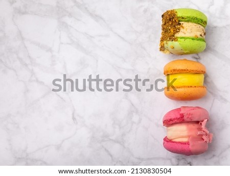 Tasty macarons on a marble background. colorful almond berry cookies.Culinary and cooking concept.Copy space.Place for text. View from above. Top view