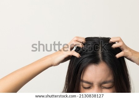 Young woman itchy head There is a fungus on the scalp dandruff, red rash She scratched her head to bring relief. Need to consult a doctor. Hair problems hair loss. Shot on isolated background Royalty-Free Stock Photo #2130838127