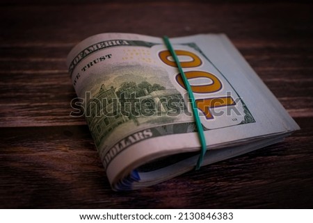 dollars twisted on wooden background