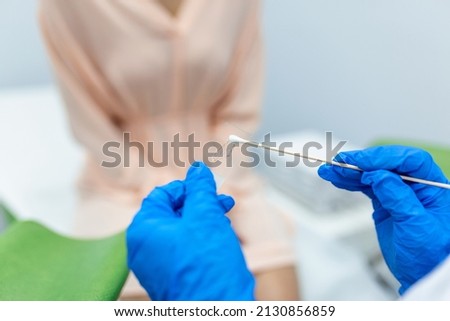 Vaginal Smear. Close-up of doctor hand holds gynecological examination instruments. Gynecologist working in the obstetrics and gynecology clinic. Royalty-Free Stock Photo #2130856859