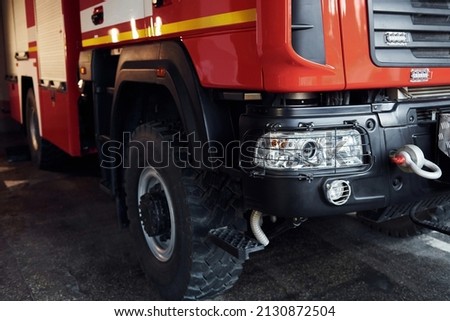 Close up view of front part of red fire truck. Natural lighting. Royalty-Free Stock Photo #2130872504