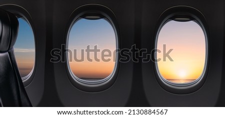 Windows and Seat Inside Airplane flying on sunset sky in the morning over ocean, Inside Plane Nobody Royalty-Free Stock Photo #2130884567