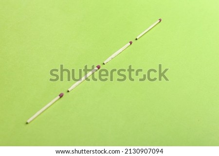 Wooden whole matches on green background