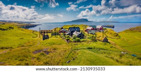Aerial landscape photography. Sunny summer view from flying drone of outskirts of Torshavn city, capital of Faroe Islands, Denmark, Europe. Attractive summer seascape of Atlantic Ocean. Royalty-Free Stock Photo #2130935033