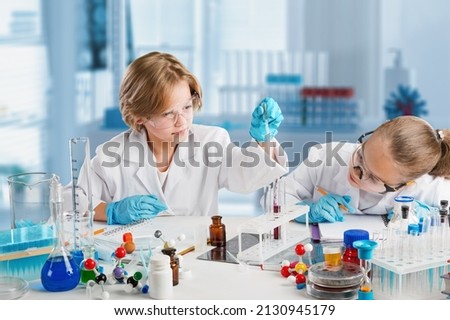 Diversity children doing a chemical experiment in laboratory . Happy kids at elementary school learning science chemistry . Chemistry school concept. Royalty-Free Stock Photo #2130945179