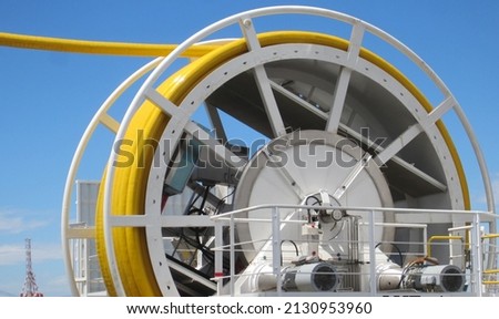 Crawler riser hose and  yellow umbilical cable on a diamond recovery boat. Close up, detail. Royalty-Free Stock Photo #2130953960