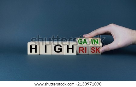 High risk or high gain. The cubes form the expression High risk - high gain. The concept of risks and profits in business